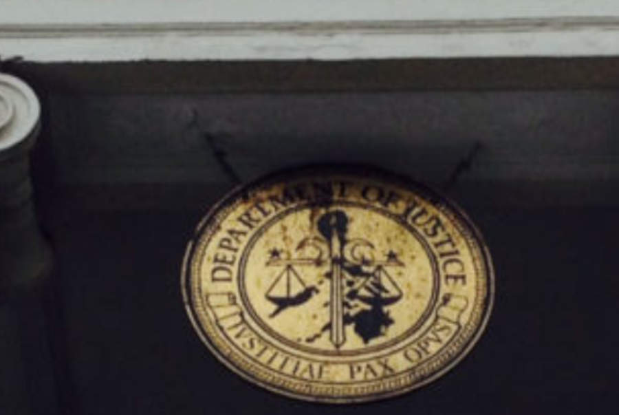 DoJ's official emblem over the front entrance of the building.